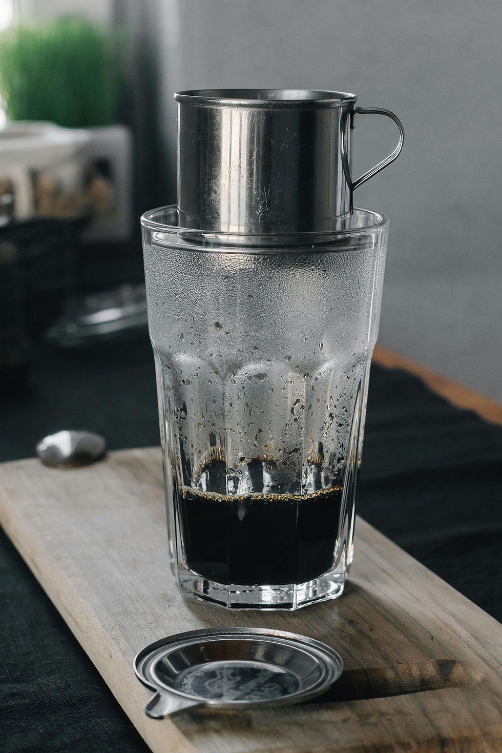Phin filter on top of a glass slowly dripping coffee