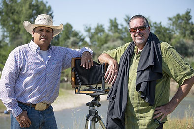 Aaron Brien with John Graybill leaning on a camera