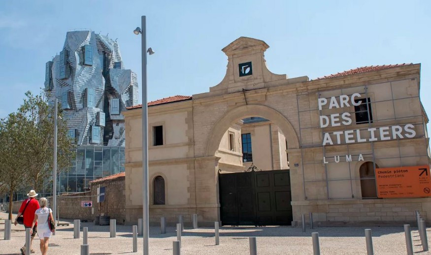 LUMA Arles includes a new Frank Gehry-designed resource center (left), restored industrial buildings, and a public park. Photo courtesy LUMA Arles.