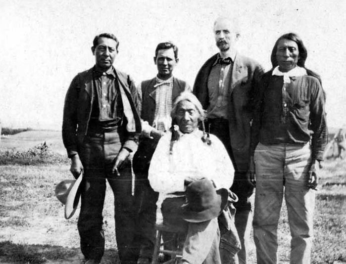 L to R, back: Alexander Upshaw, William E. Myers, Edmond Meany, ?. Front: Red Cloud, Sioux leader. Photo by Fred Meyer, 1907.