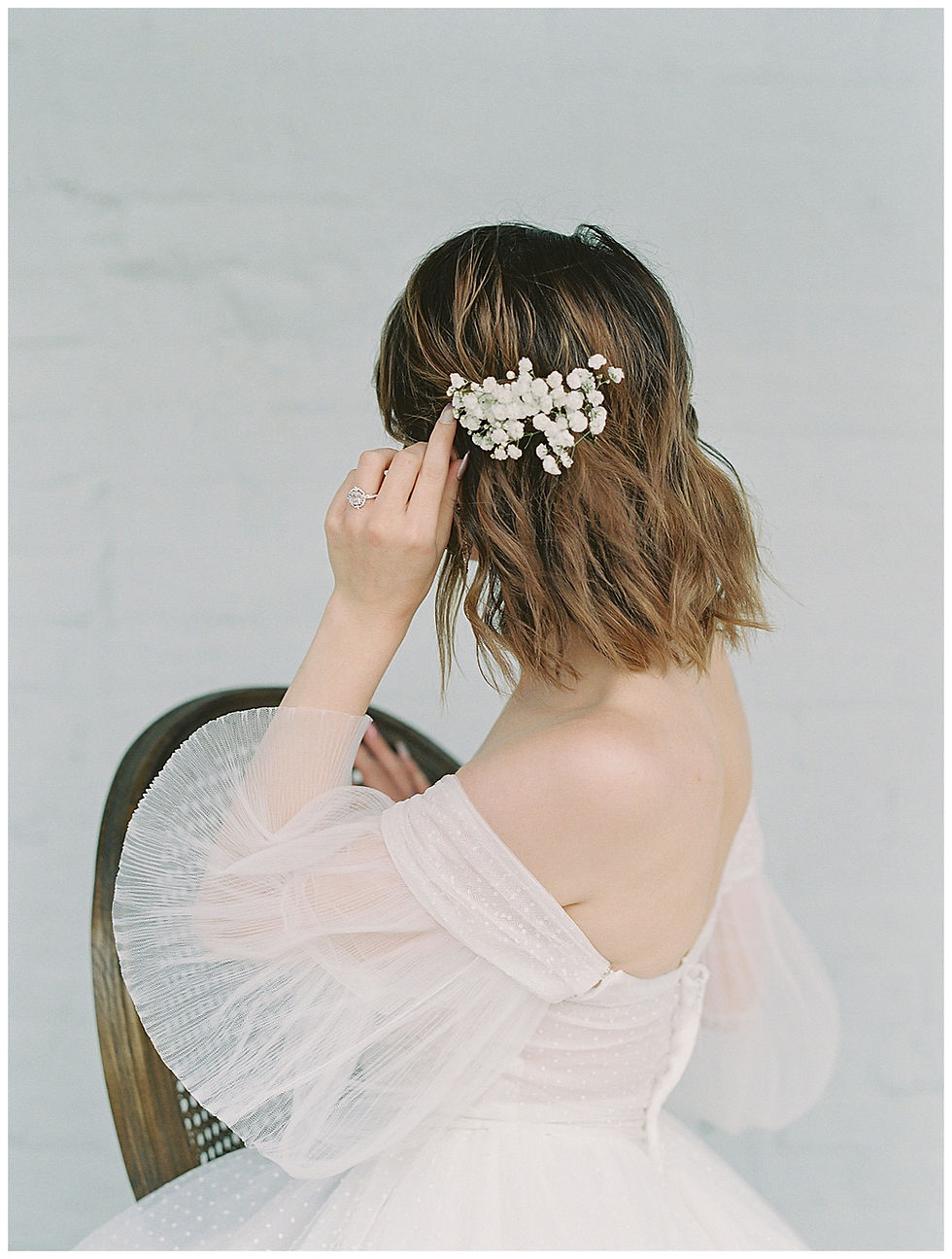 film photography , Bride Holding a pink, yellow, peach, wedding bouqet in Dallas Texas. The Place at tylerDallas, Texas. bride, Wedding dress with sleeves, bride sitting, The Place at Tyler in Dallas Texas. Flowers in hair, The Place At Tyler, Dallas Texas , dallas wedding photography