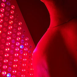 man receiving red light therapy at elixir health and wellness