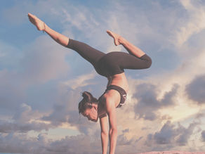 A girl balancing whilst doing a handstand