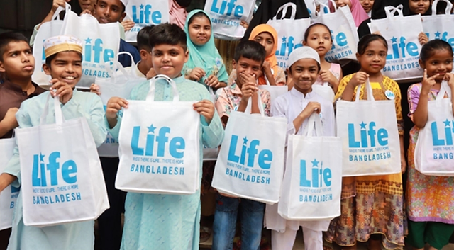 Photo of orphans holding their presents from the Global Orphan Eid party in Bangladesh.  