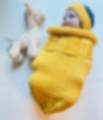 Baby in hand-knitted cocoon in Sunflower by Brooknit Bonneterie