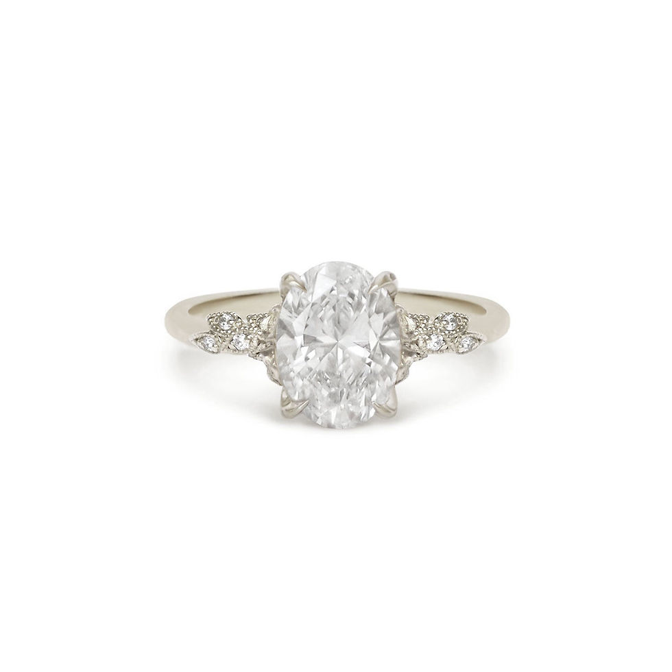 Thumbnail: Diamond ring with a large central gemstone and smaller stones on a 14k white gold