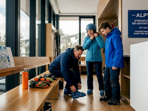 Skiers preparing equipment in morning lodge
