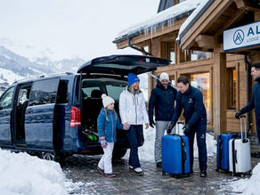 Family arriving by private transfer in snowy Val Thorens