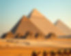 Cinematic wide shot of the Great Pyramids of Giza with a caravan of camels walking in the