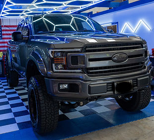 Grey Ford F-150 pickup truck, a perfect candidate for Liquid Paint Protection Film (LPF) to shield the front bumper and hood from Michigan road debris.