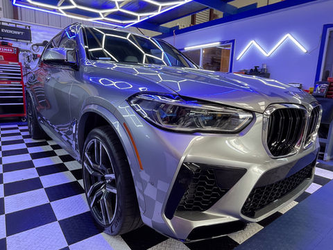Silver BMW X5 SUV featuring professional ceramic coating and paint correction.