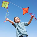 Happy and creative ten year old boy flying a kite.jpg