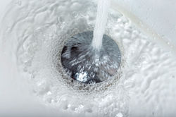 tap-water-flowing-into-stainless-steel-drain-2021-08-28-08-30-42-utc