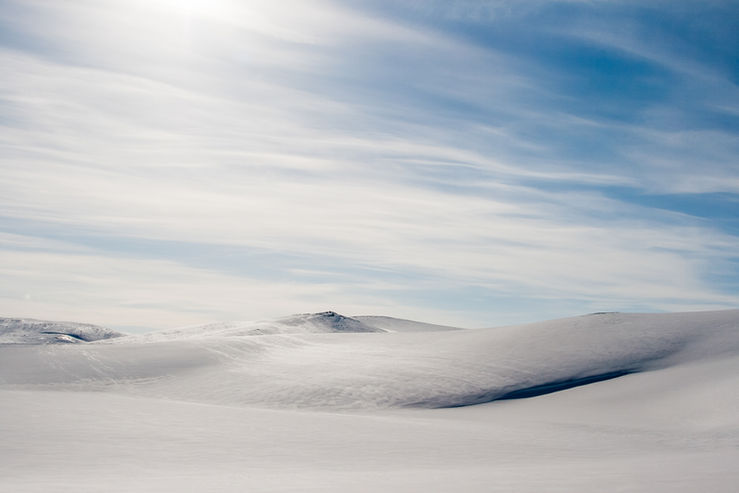 Norwegian fiord covered in snow winter day time 