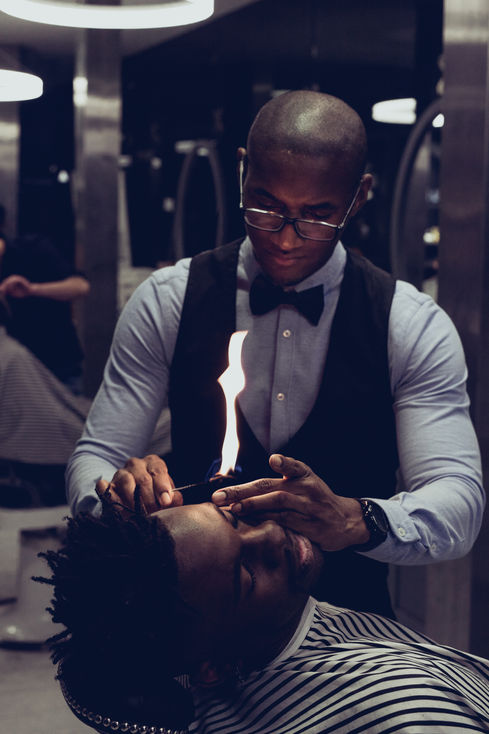Men skin and hair care procedure in action with fire 