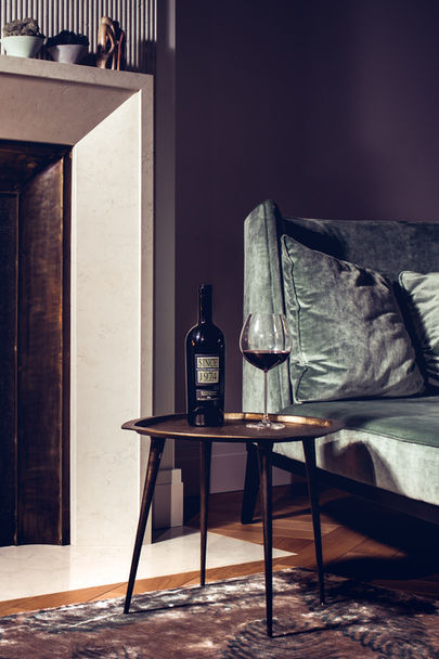 Bottle of wine on the small coper  table 