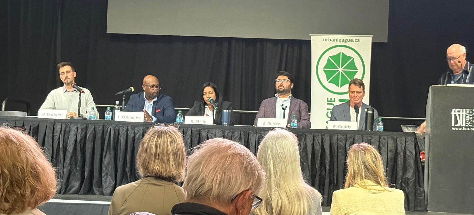 City Council candidates engage in a debate at Fanshawe College, addressing community issues to an attentive audience.