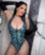 woman standing in tiled room in leopard print bodysuit