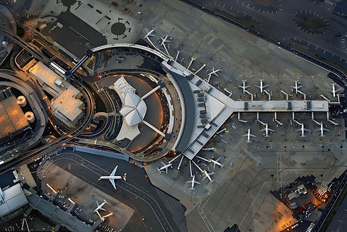 Overhead perspective of an airport featuring several aircraft on the ground