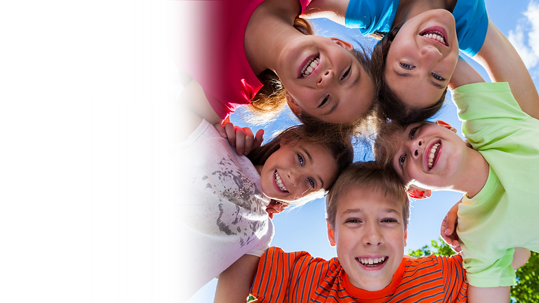 Kids leaning down and smiling at the camera in bright sunlight
