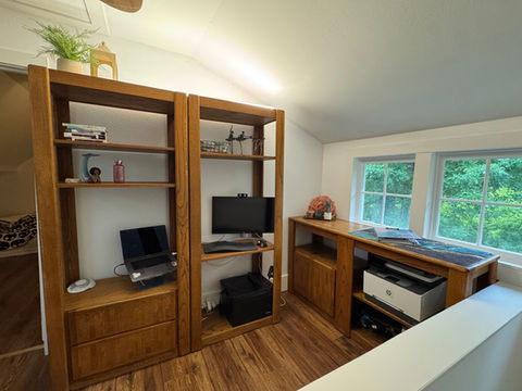 Significant storage was added with this entertainment-center-turned-office. The shelves maximize the vertical space, while the credenza fit perfectly beneath the windows. Especially in a small space, every detail matters.