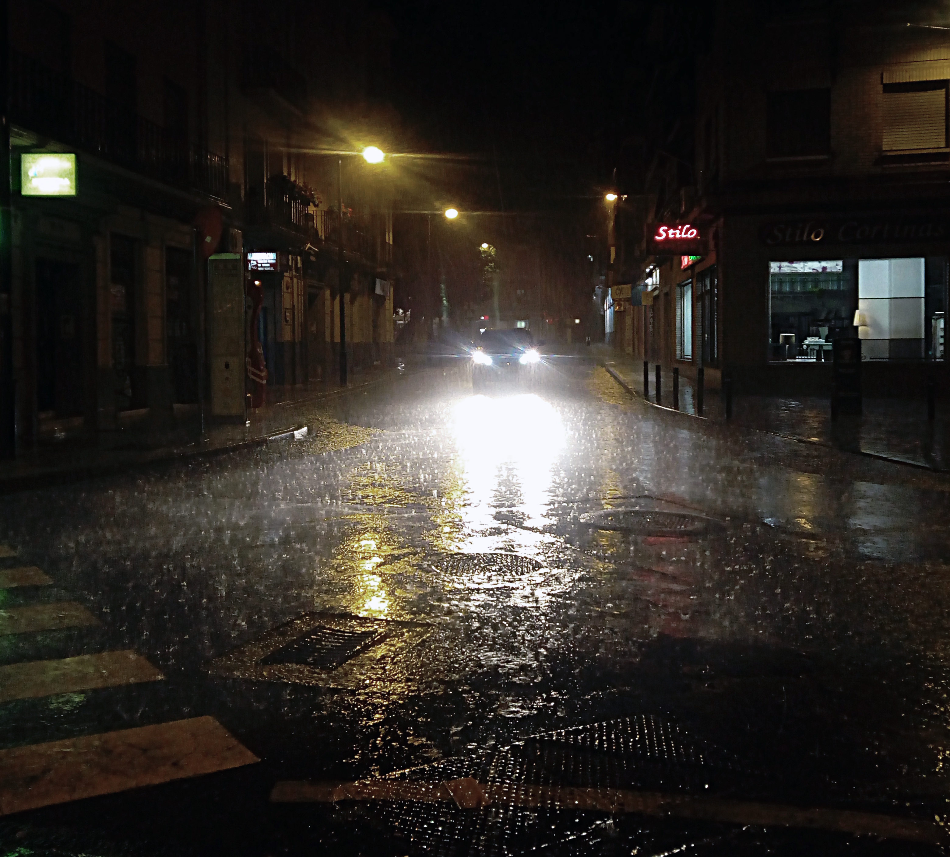 Ext. Street. Night. Rain.