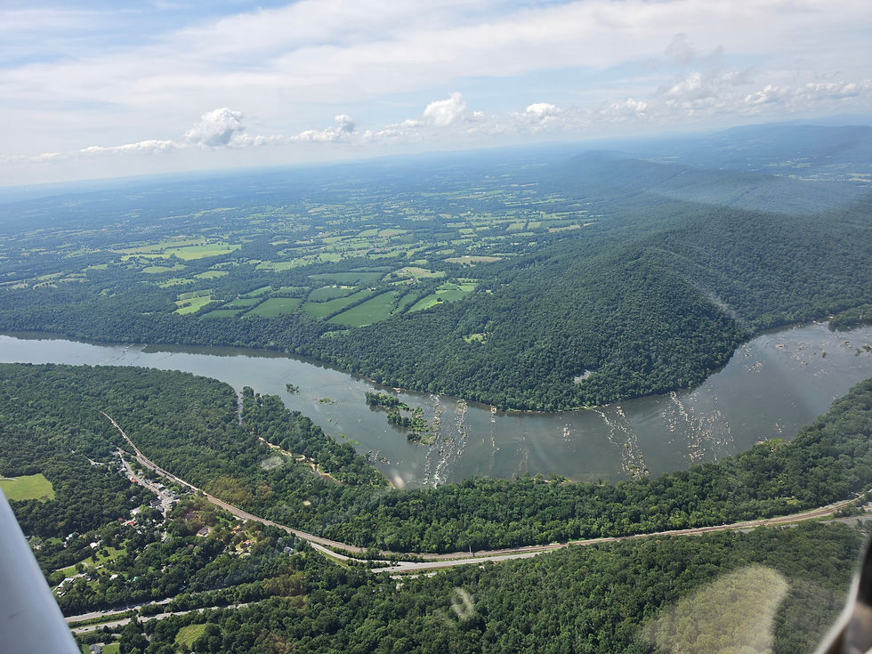 Aerial view of the Potomac River winding through green forest, representing the scenic views seen on a Tour Flight