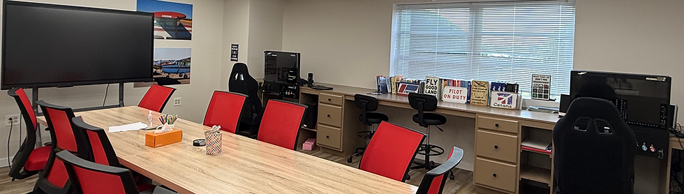 Conference room with red chairs and monitors at Bravo Flight Training, representing Part 141 versus Part 61 training programs
