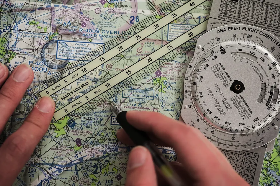 Student using an E6B flight computer and sectional chart to plan a cross-country flight, training for the Certified Flight Instructor certificate