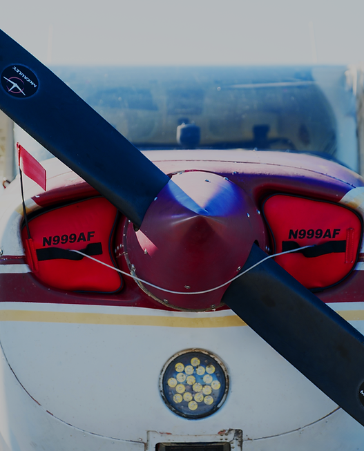 Close-up of a small aircraft's propeller and engine cowling, representing the Basic Discovery Flight
