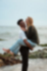 Happy couple embracing eachother at the oceans edge in Corona Del Mar