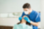 male-dentist-examining-young-woman-with-dental-carver-medical-clinic.jpg