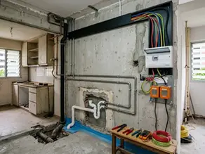 Gutted Singapore HDB kitchen undergoing electrical rewiring and plumbing replacement by Cosmos Decor.