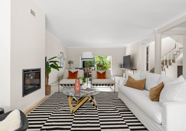 Contemporary living room with layered textures and warm coastal palette – Estoril home staging