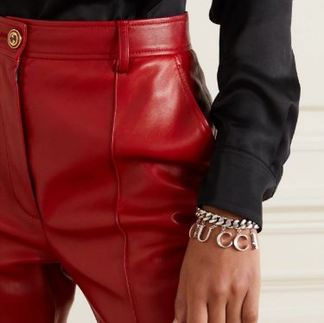 Red Leather Pants w/ Gucci Bracelet and black silk top to complete the best fall and winter 2023 trends. pair with black heels and an updo hair style.