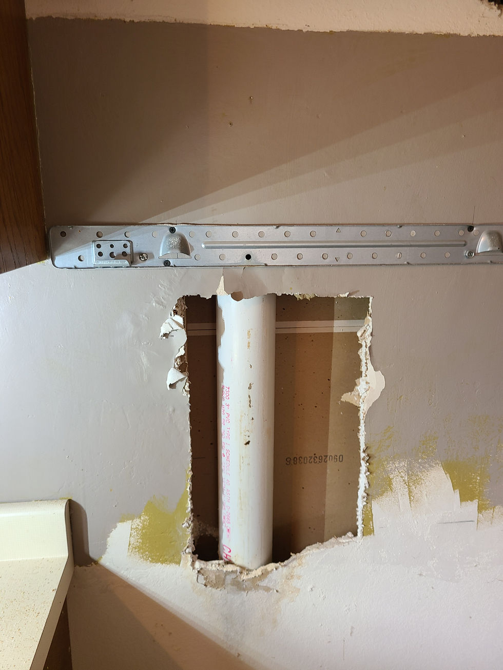 A PVC drain pipe has a hole in it.