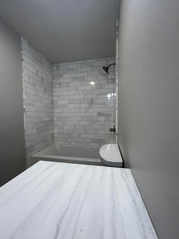 Marble surround deep soaker tub, with porcelain floors, James Martin 48 inch vanity. Wedi-board warranty. Ann Arbor, MI 