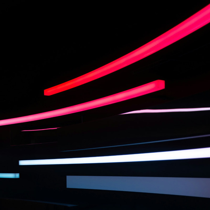 Strips of red, white and blue light curving towards the right