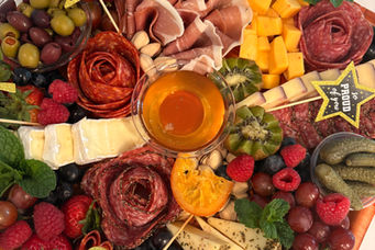 Large graduation charcuterie board with artisan cheese, cured meats, and Class of 2025 celebration decorations in NJ