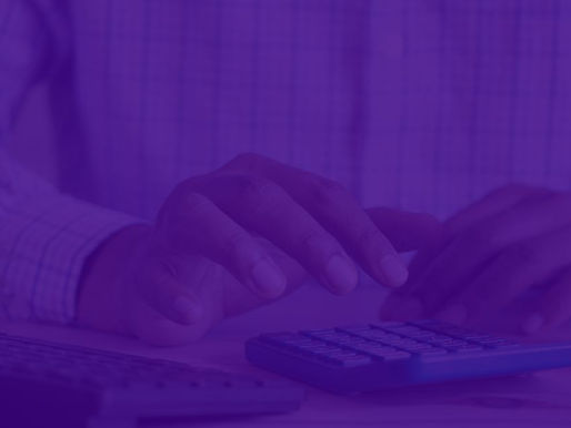 An accountant on his desk with a calculator.