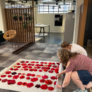 Sarah Ritchie and Clare Hocking assemble the "Held in Remembrance" hand-made felted poppy installation.