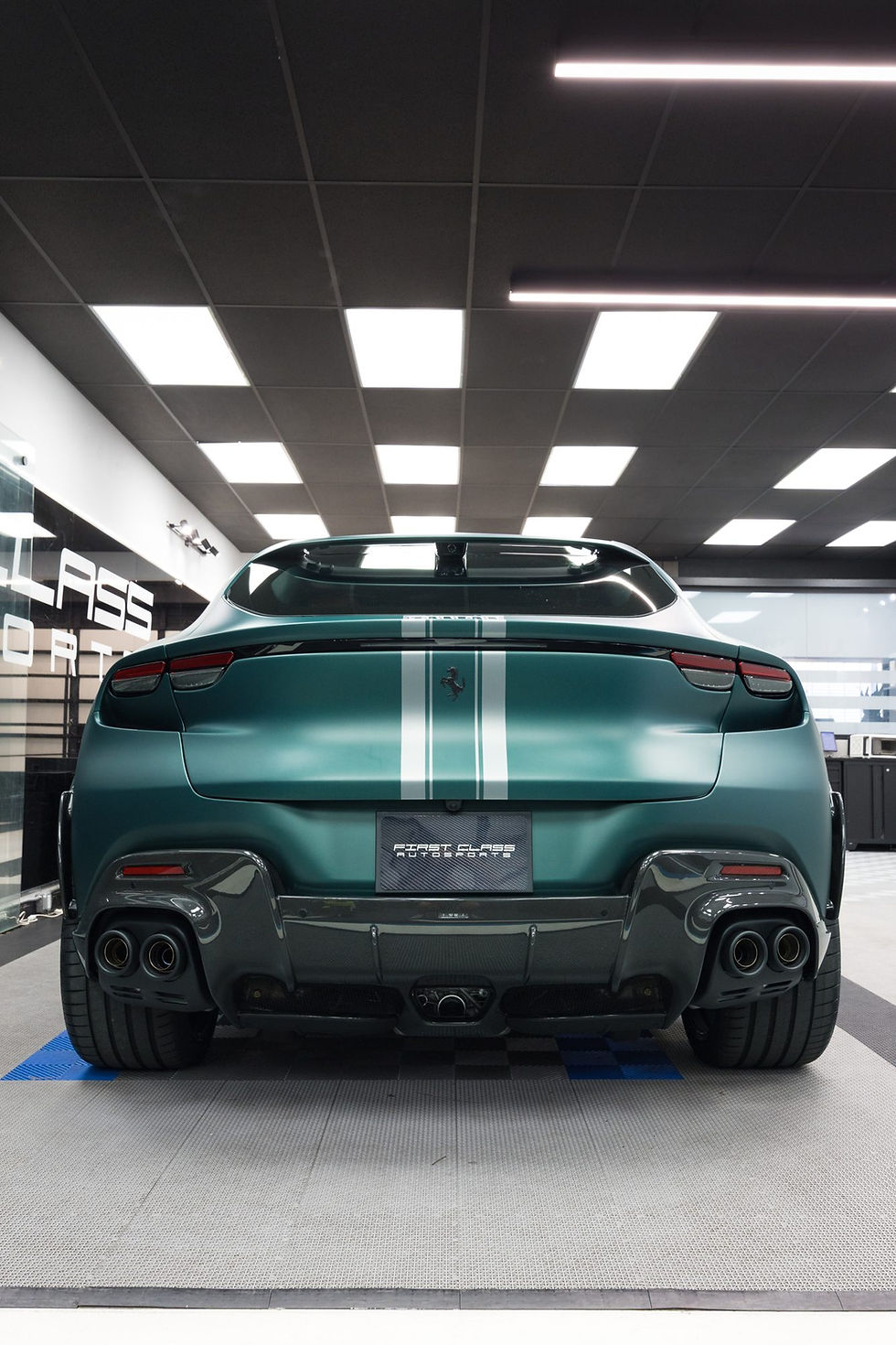 Rear of a Ferrari Purosangue with satin Stealth PPF paint, factory silver stripes and gloss carbon diffuser