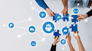 Hands join together to assemble puzzle pieces, symbolizing collaboration and teamwork in a