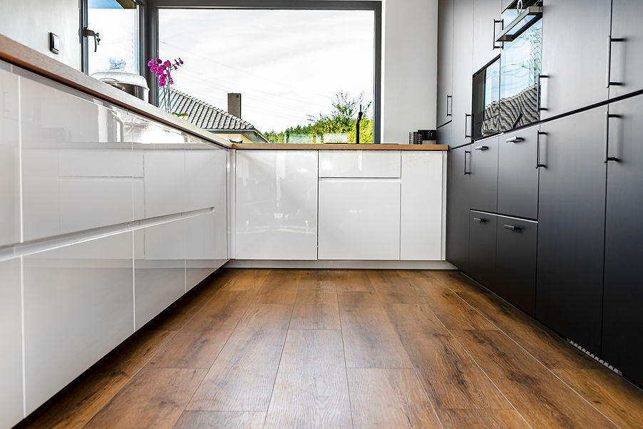 Black and white kitchen cabinets with vinyl flooring