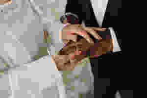 Elderly couple exchanging rings