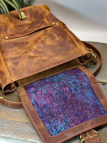 Leather backpack with fabric panel