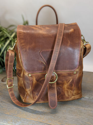 Leather backpack designed to carry laptop