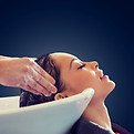beauty-salon-people-concept-happy-young-woman-hairdresser-hands-washing-head-hair-blank-bl