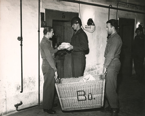 German POWs return laundry to prisoners under guard