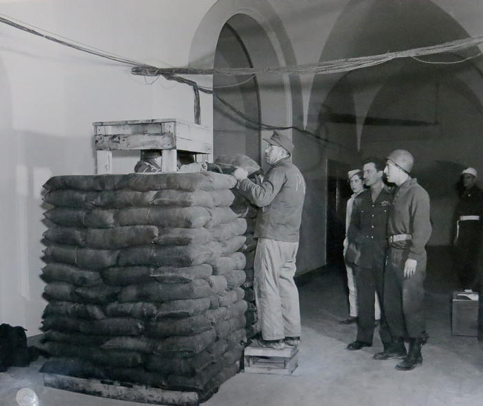 German POW constructs a sandbag barricade for security in the Palace of Justice